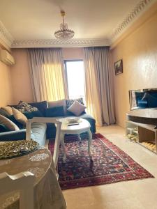 a living room with a couch and a table at Luxury apartment 3 in the heart of Gueliz, Wifi, Pool in Marrakech +16 photos