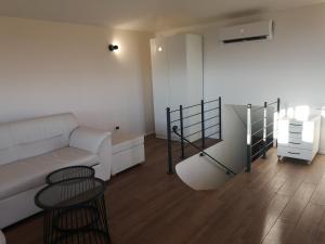 a living room with a couch and a table at Vila Magnolia in Vilanija