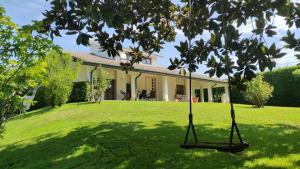a house with a yard with a swing at VILLA SAVALIN in Taglio di Po +17 photos