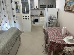 a kitchen with a table and a kitchen with a refrigerator at Sea View apartment in Vlorë +3 photos