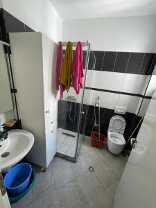 a bathroom with a shower and a toilet and a sink at Sea View apartment in Vlorë