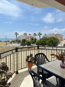 a patio with a table and chairs on a balcony at Apartments with a luxurious location near the sea in Paphos