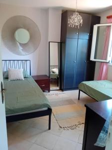 a bedroom with two beds and a mirror at Sunday Villa in Agios Georgios