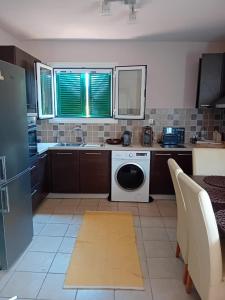 a kitchen with a washer and dryer in it at Sunday Villa in Agios Georgios +6 photos