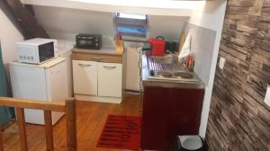 a small kitchen with a stove and a microwave at Ma niche à louer in Cherbourg en Cotentin