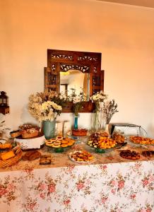 a table with many plates of food and a mirror at B&B Antico Casale in Fuscaldo