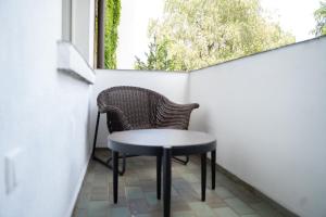 a table and chairs on a balcony with a window at JUNIK Apartments Oberhausen No º11 in Oberhausen