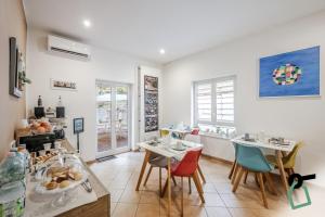 a dining room with two tables and chairs at Residenza Scarlatti Napoli in Naples