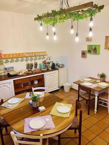 a kitchen and dining room with tables and chairs at Podere al Fico B&B in Cecina