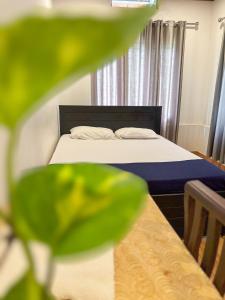 a small bedroom with a bed with white sheets at kadalundi Heritage in Vallikunnu