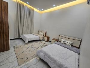 Giường trong phòng chung tại فيلا امين