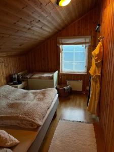 a small room with two beds and a window at Hytte i Målselv Fjellandsby in Bergset +9 photos
