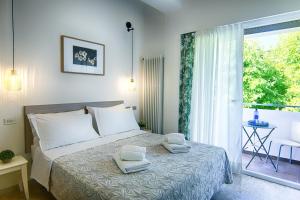 Postel nebo postele na pokoji v ubytování Albergo Villa Lucia