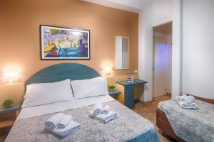 Postel nebo postele na pokoji v ubytování Albergo Villa Lucia