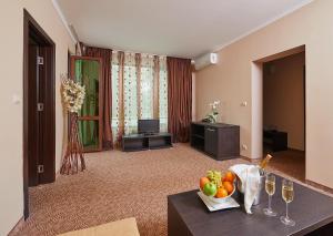 a living room with a table with a bowl of fruit at Central Plaza in Pomorie +59 photos