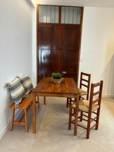 a wooden table with two chairs and a bowl on it at Cal Ferrer in Benimeli +14 photos
