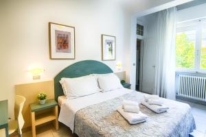 Postel nebo postele na pokoji v ubytování Albergo Villa Lucia