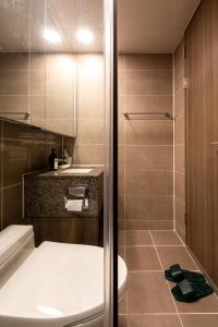 a bathroom with a toilet and a sink at High floor view accommodation in Busan +22 photos