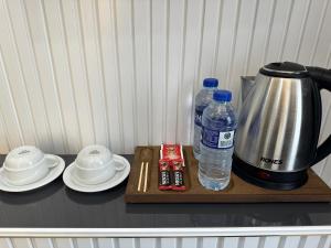 a table with a coffee maker and two bottles of water at Kosova Hotel in Istanbul