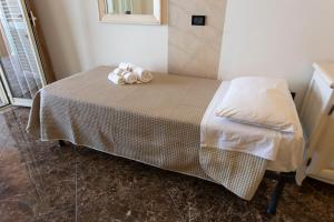 a bed with two towels sitting on top of it at Hotel Terrazzo Sul Mare in Tropea