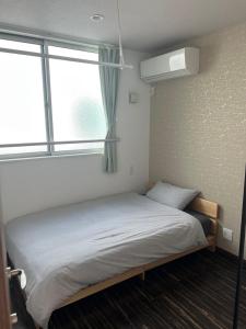 Postel nebo postele na pokoji v ubytování 民泊TOKYO one シェアハウス