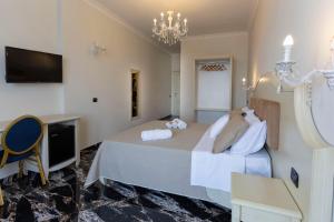 a bedroom with a large bed and a television at Hotel Terrazzo Sul Mare in Tropea