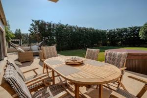 a wooden table and chairs on a patio at Harmony Villa in Schinias