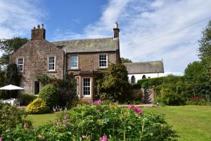 an old house with a garden in front of it at Applegarth House in Lockerbie