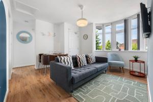 a living room with a couch and a table at 4BR 3 bath Spacious apartment, Sleeps upto 8 free parking in Allesley