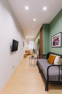 a bedroom with a bed and a living room at Patong Apartments Steps to Beach & Bangla Road Sleeps 6 in Patong Beach