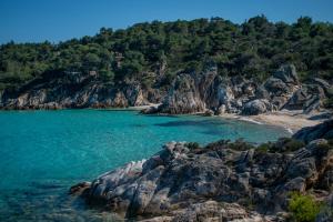 a view of a beach with rocks and water at Angie's House Sykia in Sikia