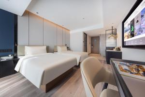 Postel nebo postele na pokoji v ubytování Atour Hotel Changsha Wanjiali Middle Road Gaoqiao North