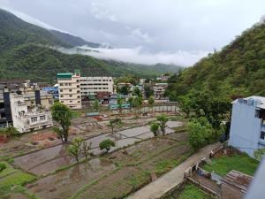 a view of a city with a mountain at Welcome Home Stay & Hotel Tapovan Rishikesh in Rishīkesh