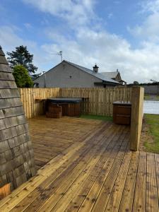 a backyard with a wooden deck with a fence at EC&C RETREATS in Dungannon