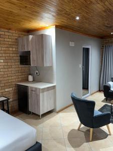 a bedroom with a bed and a desk and a chair at 801 Guesthouse in Springs
