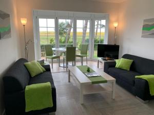 un soggiorno con due divani e un tavolo di Jan und Jana Ferienhaus a Ahrenshoop