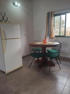 a kitchen with a table and a white refrigerator at El Caburé in Concepción del Uruguay