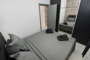 a bedroom with a bed with two slippers on it at Porto in Ðenovići