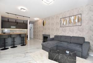 a living room with a couch and a kitchen at Porto in Ðenovići