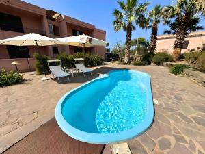 a swimming pool in the middle of a patio at Marchetti Home in Pantelleria