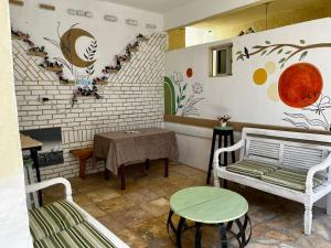 a room with a table and a bench and a table and a table at Recanto Canoa - Canoa Quebrada in Aracati