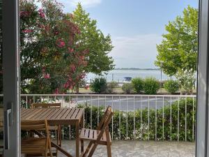 a table and chairs on a balcony with a view of the water at Appartamento con vista laguna in Grado +14 photos