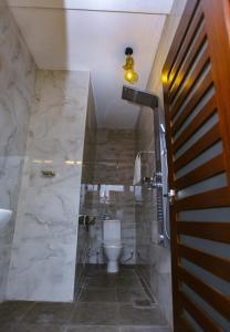 a bathroom with a toilet and a sink at Sakura Surf Lanka Hotel & Restaurant in Weligama +43 photos