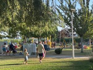 a man and a child playing in a park at Liliom a Strandnál in Balatonfüred