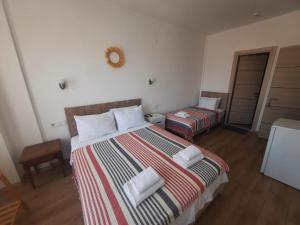 A bed or beds in a room at Adil Pansiyon