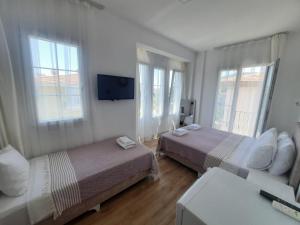 A bed or beds in a room at Adil Pansiyon