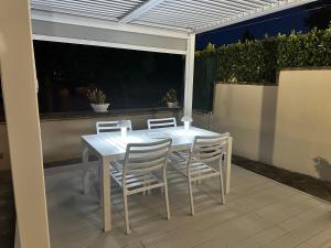 a white table and chairs sitting on a patio at Villa Cattleya in Casciana Terme