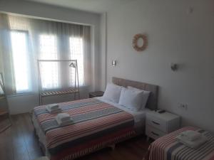 A bed or beds in a room at Adil Pansiyon