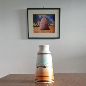 a vase sitting on a table in front of a painting at la terrazza sul viale in Circello +12 photos