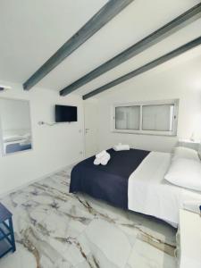 a bedroom with a large bed with towels on it at Lume Laura ROOMS in Capaccio-Paestum +18 photos